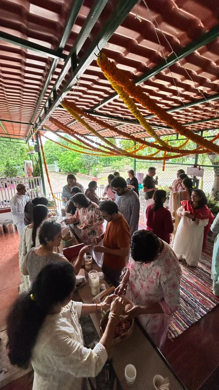 Community serving prasad under the marigold canopy