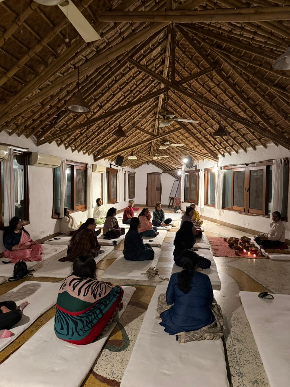 Group meditation in the thatched hall
